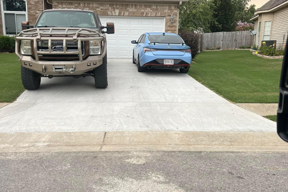 Professional smoothing and finishing of a concrete driveway surface